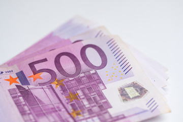 Part of a five hundred euro bills stack, closeup money shot on white background