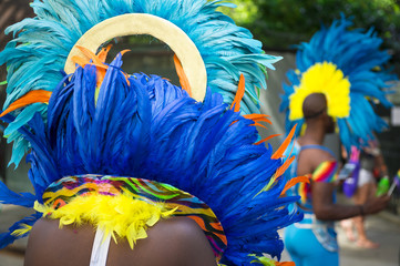 Group of dancers wearing colorful feathers costumes gathered for a carnival parade
