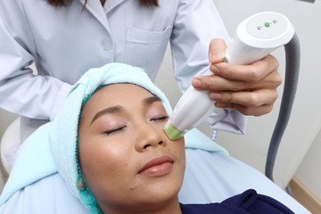 Treatment on Asian Woman as patient to make skin smooth bright