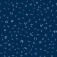 abstract seamless pattern made of snowflakes on blue. Christmas background for design of posters, postcards, invitation for the new year.