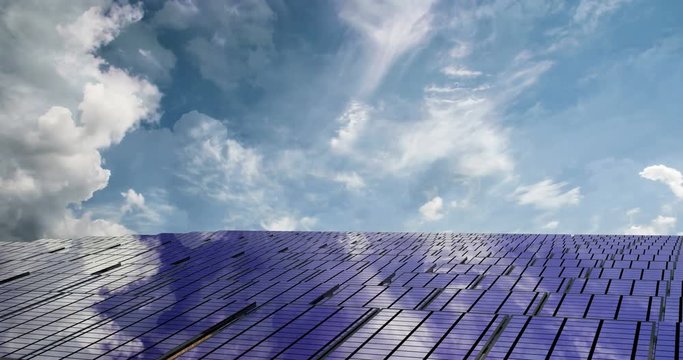 Solar panels on the beautiful cloudy sky, time laps