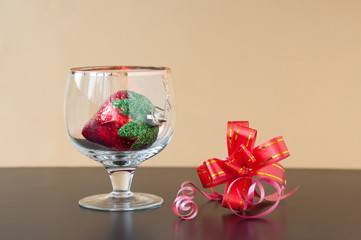 Toy strawberry  in a glass, and red bow