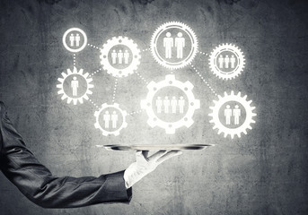 Waiter hand with white gloves holding silver plate full of social media communication icons