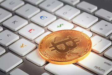 Golden Bitcoin on white keyboard with euro, dollar, pound, and yen currency symbols on buttons