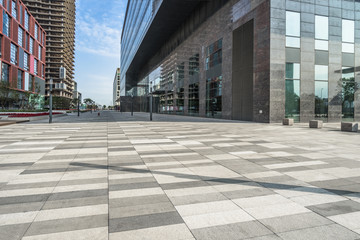 modern glass building exterior with empty pavement