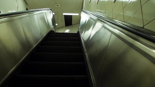 A POV shot of riding the escalator up in a subway station