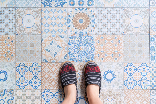 top view of fabric pattern shoes with oriental tiles floor and copy space.