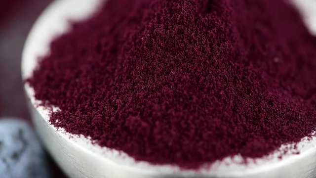 Blueberry powder on a rotating plate as 4K UHD footage (seamless loopable)