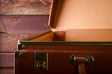 Old vintage, retro open suitcase on dark background. Front view
