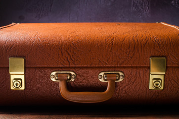 Old vintage, retro open suitcase on dark background. Front view