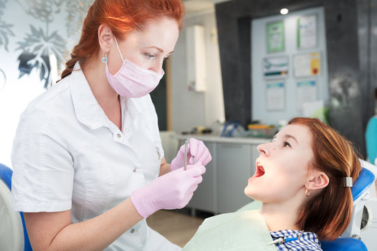 young woman opened her mouth at dentist reception
