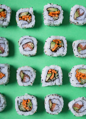 Japanese sushi on a green background. Rolls for dinner or lunch