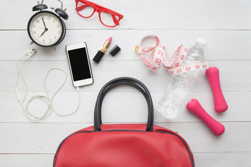 Flat lay of woman essentials and sport equipments on white wooden background, Lifestyle beauty and healthy concept