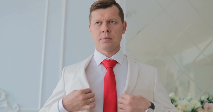 groom tunes his jacket