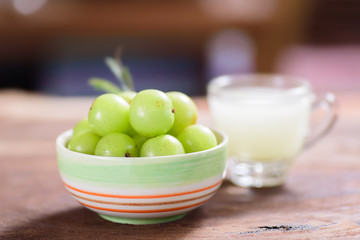Indian gooseberry fruit and juice on wooden background,healthy food