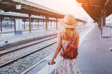 travel background, woman traveler with baggage, passenger waiting for the train on platform of...