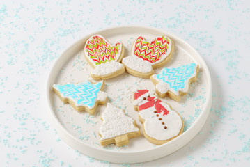 Festive Christmas snowman Cookie with decorated trees on white background.