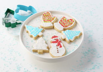 Obraz na płótnie Canvas Festive Christmas snowman Cookie with decorated trees on white background.
