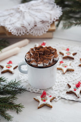 Obraz na płótnie Canvas Composition of book with cup of cocoa with marshmallow and Christmas decorations on table, gingerbread festive stars