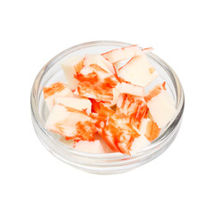 Chopped crab sticks in a transparent bowl. Isolate