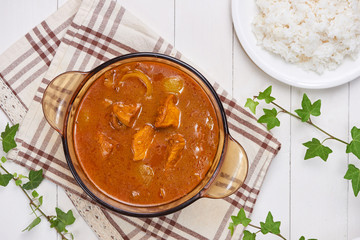 Chicken curry with spice on wooden background
