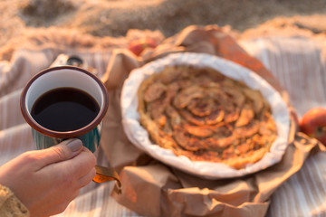 female hand holding a mug with tea 