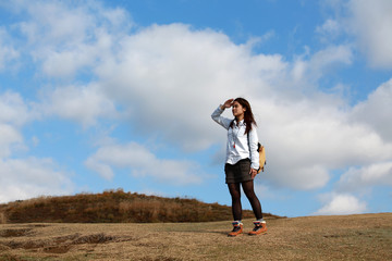 outdoor girl walk on the peak, have a good view on the top mountain range, to look far into the distance in good weather in Nara, Japan. clouds background