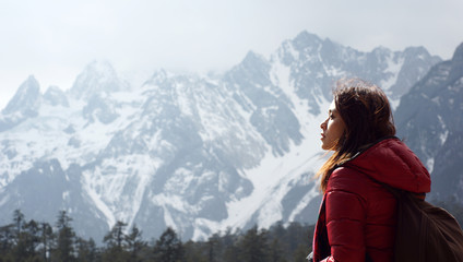 beautiful model Looking up to the sky, side view with the sun shine on face in travel with the snow...