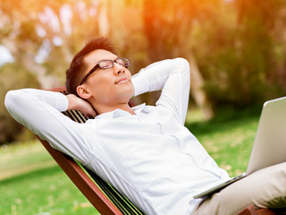 Young businessman relaxing during her break in park