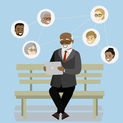 old man is sitting on the bench and chatting online with a tablet, Internet chat