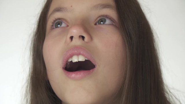 Beautiful happy teenage girl is surprised close-up on white background stock footage video