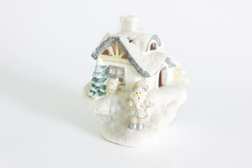 Decorative house with a candle inside on a white background