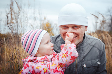 Father and his daughter child girl have fun in the field
