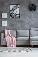 Concrete textured wall, gray couch