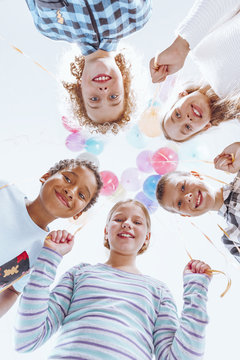 Colorful balloons hanging above kids