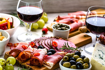 Selection of food, wine snack set on table, italian antipasti, prosciutto, salami, olives, cheese...