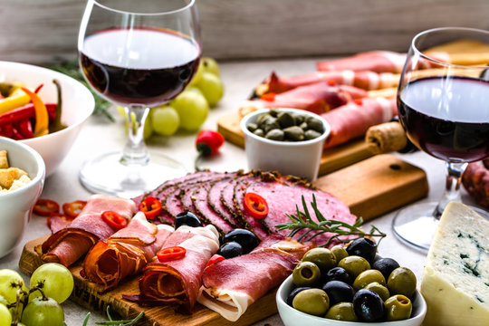 Selection of food, wine snack set on table, italian antipasti, prosciutto, salami, olives, cheese and other appetizer on platter