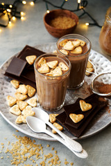 Milk chocolate with Heart Cookies in glasses. Ingredients in the background 
