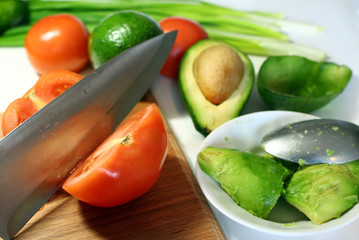 the process of making salad, slicing vegetables with a knife