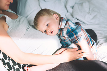 Pregnant mother and son at home.