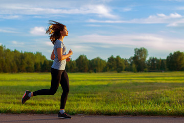 Teen girl runner in the park