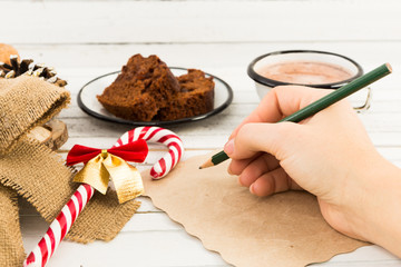 Woman hand writing a letter to Santa Claus
