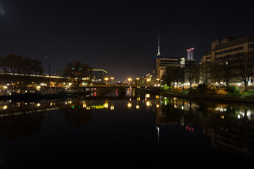 city buildings by the river in the night