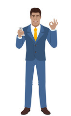 Businessman with mobile phone showing a okay hand sign