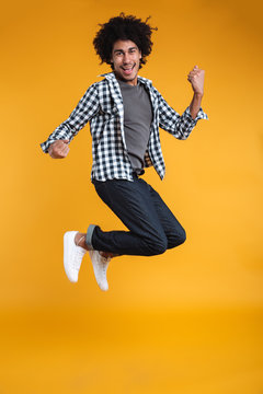 Full length portrait of a happy young african man jumping