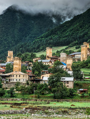 Obraz premium View on swan towels in Mestia, Svaneti region, Georgia. Misty fod above green forest.