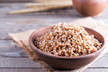 Buckwheat porridge in a bowl on a wooden table