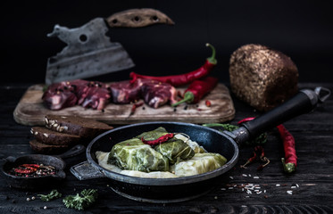 Golubtsi with clhilli paper. Cabbage rolls with meat, rice and vegetables. Stuffed cabbage leaves with meat. Dolma, sarma, sarmale, golubtsy or golabki. Dark background.