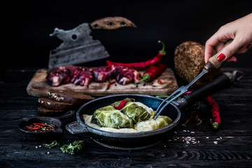 Golubtsi with clhilli paper. Cabbage rolls with meat, rice and vegetables. Stuffed cabbage leaves with meat. Dolma, sarma, sarmale, golubtsy or golabki. Dark background.