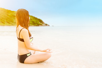 Fototapeta na wymiar Young asian women in bikini on beach,relaxing concept.